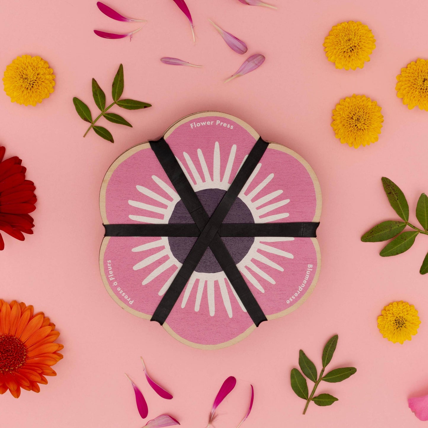 Pink flower-shaped flower press